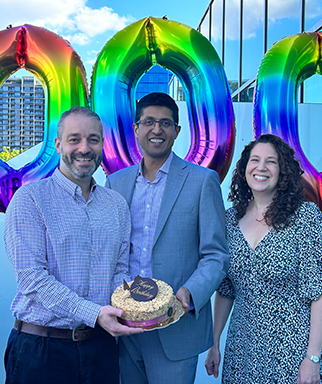 Fertility specialists Dr Hugo Fernandes, Dr Sameer Jatkar and Dr Nicole Hope posing with a cake while celebrating the clinic's 1,000th baby milestone.